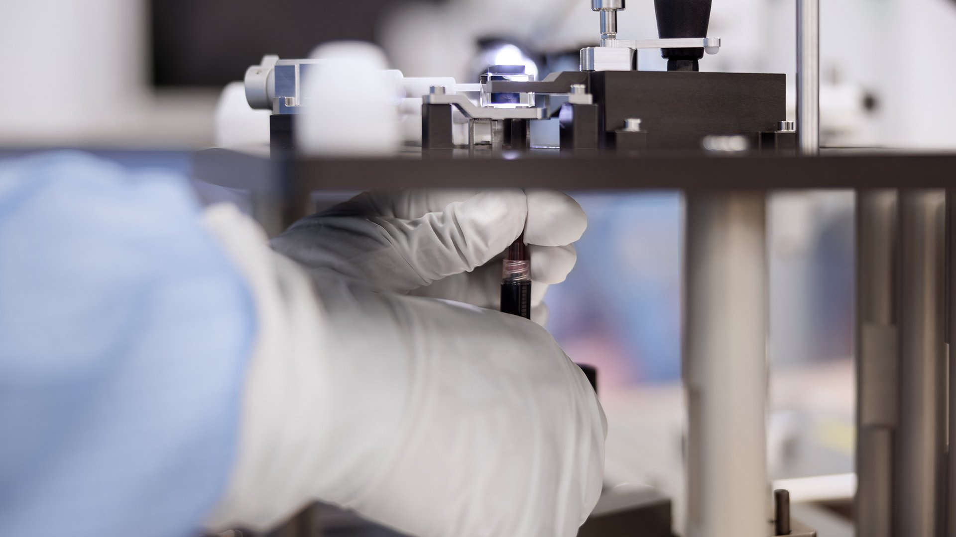 Technician adjusting precision equipment Technician adjusting precision equipment