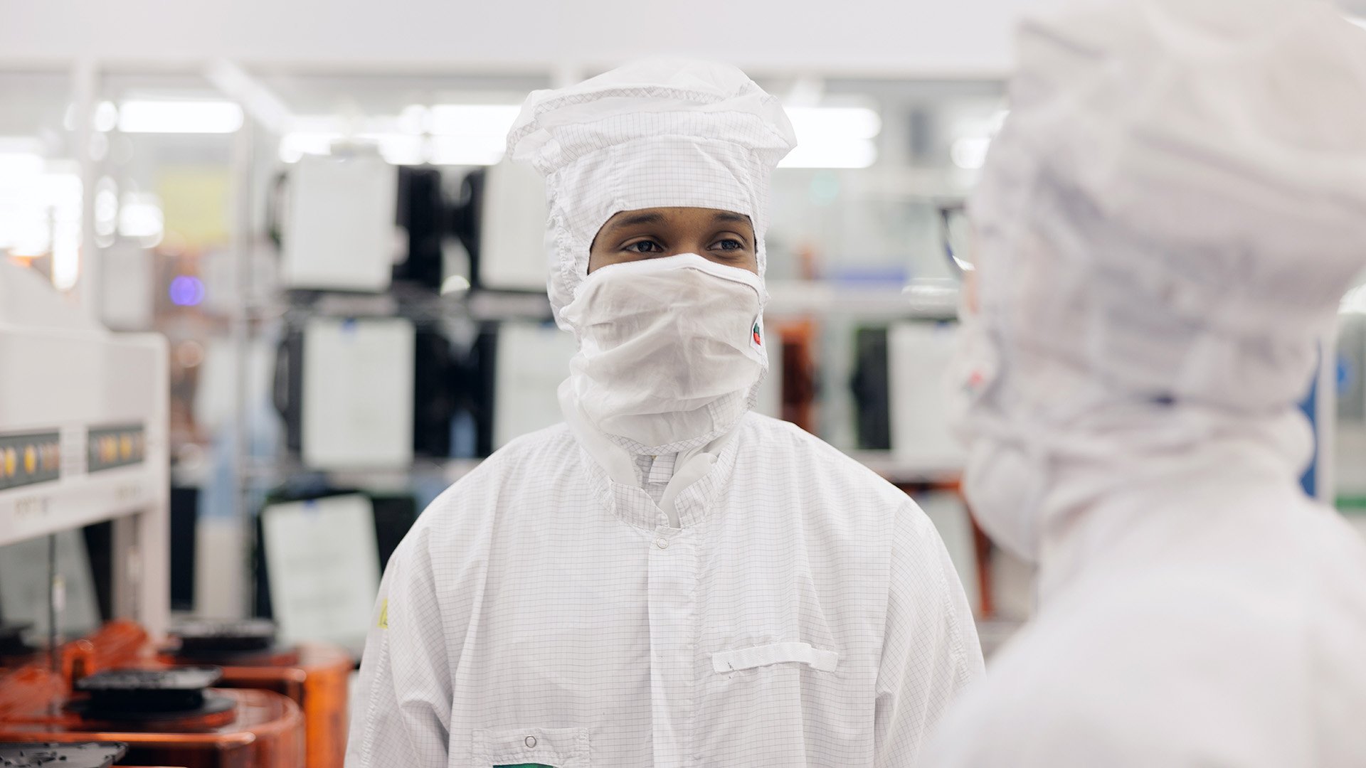 Technicians talking inside an ASML facility Technicians talking inside an ASML facility