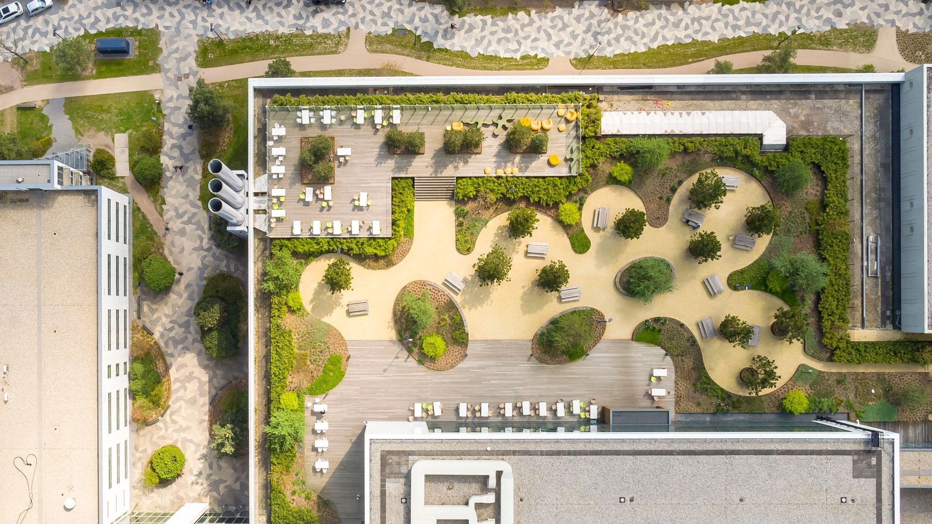 drone shot of ASML campus with paths and trees drone shot of ASML campus with paths and trees
