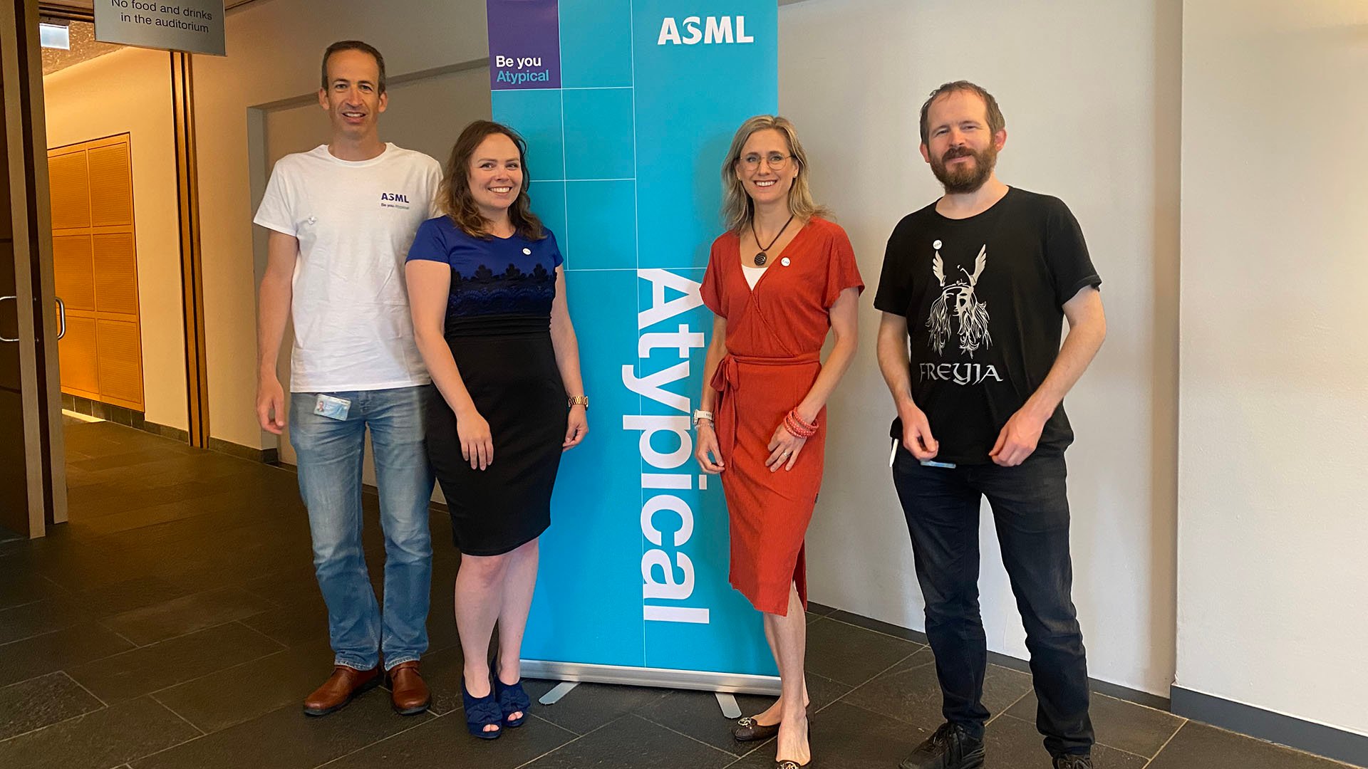 ASML neurodiversity employee network board members stand next to a banner bearing the name ‘Atypical’. ASML neurodiversity employee network board members stand next to a banner bearing the name ‘Atypical’.