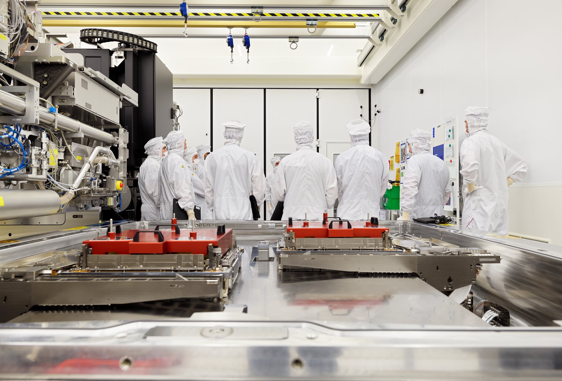 Wafer table and ASML engineers ASML engineers work on EUV system, overlooking a wafer table.